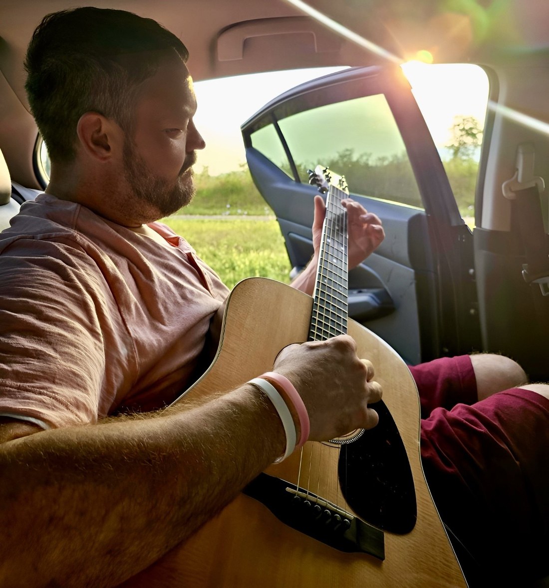 John Leonard playing acoustic guitar